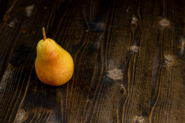 istock fresh red pear with yellow color on the table 2193448901