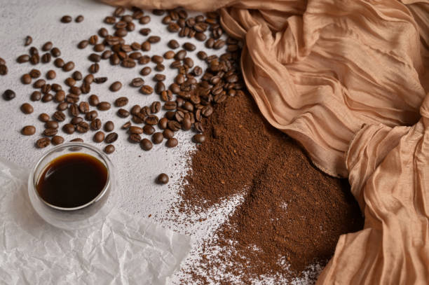 istock Fresh aromatic grain, ground and coffee drink, white background, brown cloth 2193448926