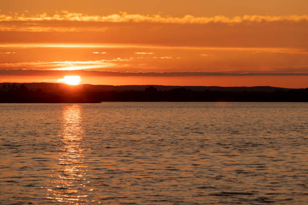 istock beautiful sunset with sun and orange sky on the lake 2193449053