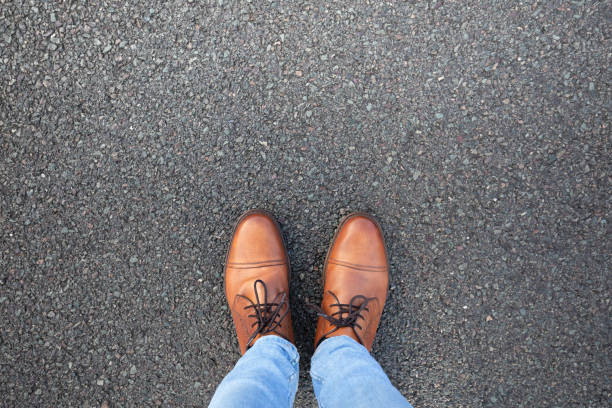 Looking down at shoes on the road