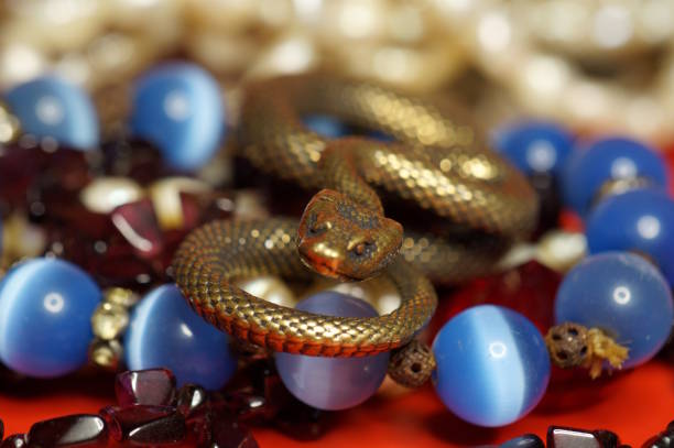 istock Various jewelry and a snake figurine. Luxury items. 2193450757