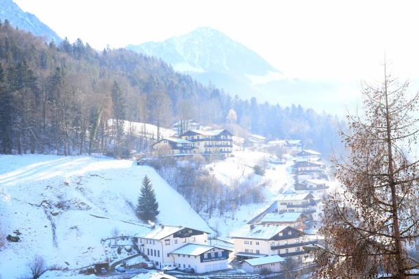 winter landscape with hilly terrain and snow cover. There are traditional houses on the slope