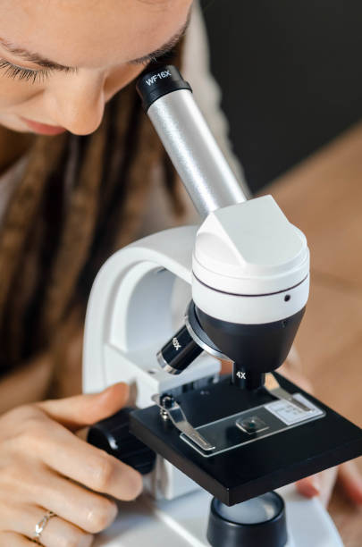 istock Young female scientist takes samples of pine mature wood. She is studying, preparing materials for research for her scientific work - stock photo 2193451663