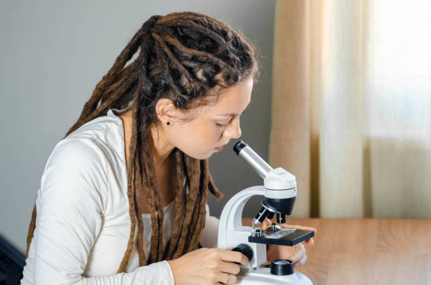 istock Young female scientist takes samples of materials and substances she is studying, preparing them for research for her scientific work- close up microscopic equipment - stock photo 2193451670