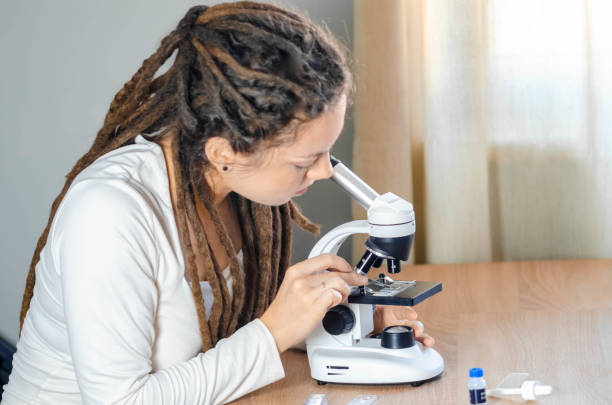istock Young female scientist takes samples of materials and substances she is studying, preparing them for research for her scientific work- close up microscopic equipment - stock photo 2193451671