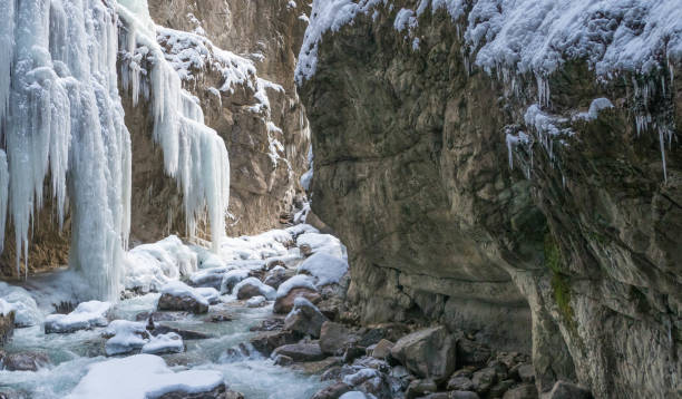 istock Icicles on rocks in rocky gorge 2193454336