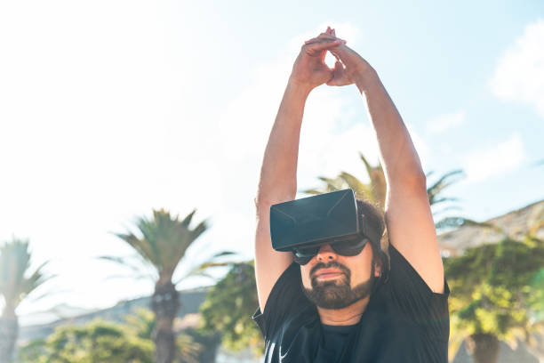 istock A man wearing a virtual reality headset is stretching his arms 2193455096
