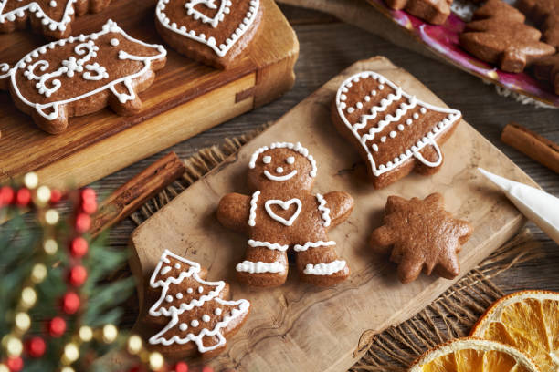 istock Decorating homemade gingerbread Christmas cookies with icing 2193456458