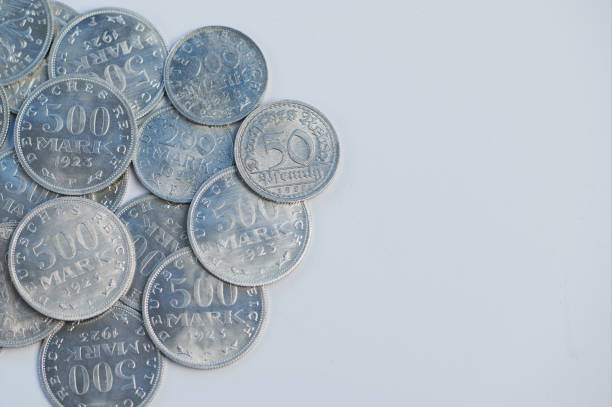 Deutsche Alte Reichsmark coins from 1923 displayed on a white surface, highlighting their details.