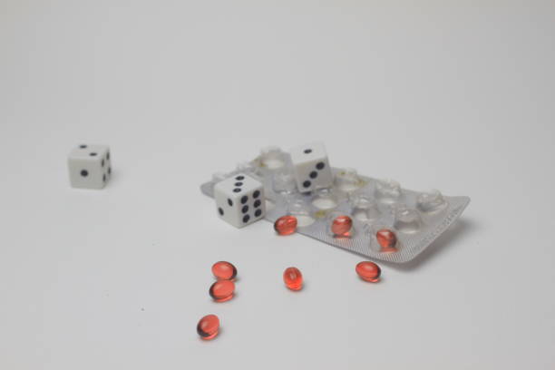 istock Dice and Pills on a White Background 2193461743