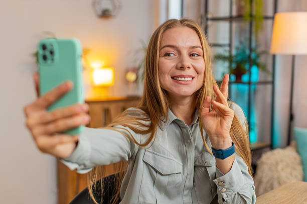 istock Caucasian mature woman freelancer using smartphone having video call smiling while sitting at table 2193469608