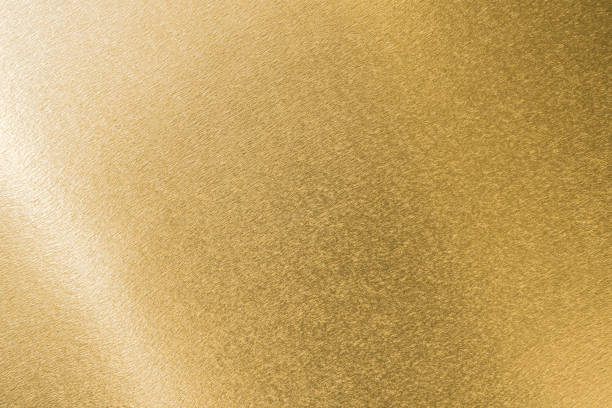istock Gold background foil leaf metallic golden texture  gradient light shiny wrapping paper bright yellow solid color wallpaper for design decoration element 2193470893