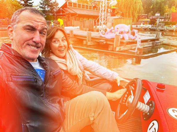 Couple posing in a amusement park in lomo style photo. Lomo photograhy is a technique that emulates old-style, especially Russian-made cameras. Lens and color distortions are the prominent features of this technique.