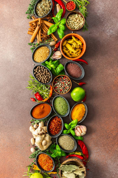 istock An artistic display of fragrant herbs and spices, scattered on a brown surface, blending natural hues and rich textures for a rustic culinary charm 2193478976