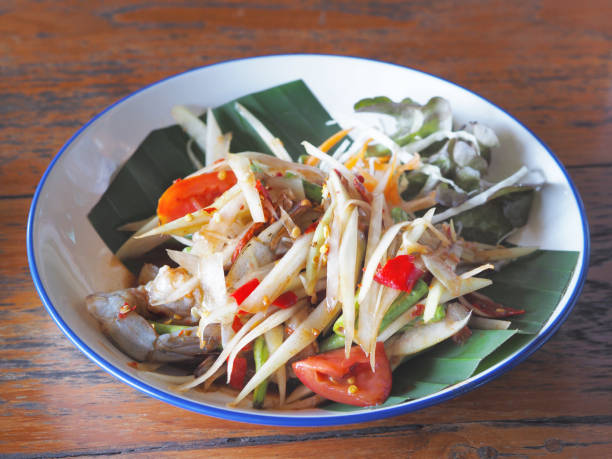 istock spicy papaya salad with raw prawn in white plate 2193489558