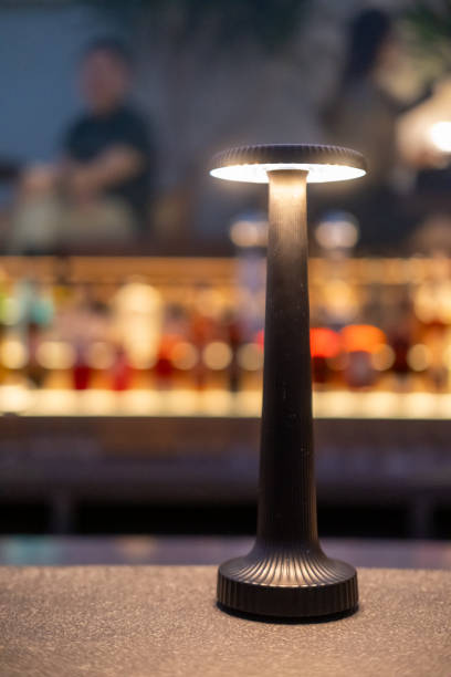 istock Table lamp on the bar, with blurred illuminated bottle display on the background 2193495124
