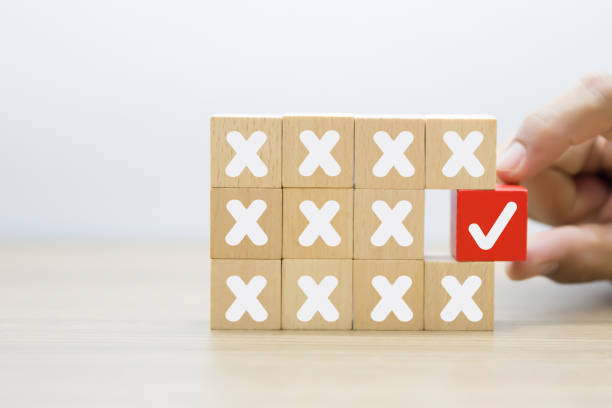 istock Hand choose check mark with cross symbol on wooden toy stack for true or false changing mindset or way of adapting to change leader and transform quiz answer and poll concept. 2193495511
