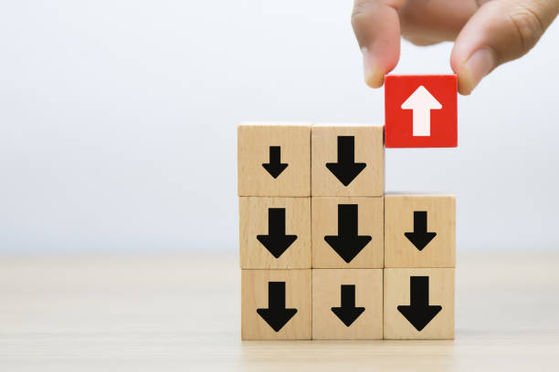 istock Hand chooses arrow icon point to the opposite side on wooden toy block stack for adaptation challenge change transformation business plan and choice the way forward goal to growth 2193495521