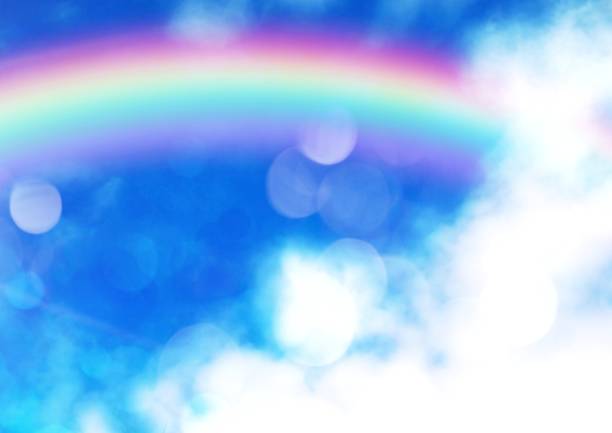 Rainbow in the blue sky with clouds and sun. Nature background.