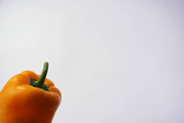 yellow bell peppers on wooden table, set of vegetables