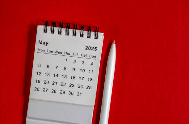 istock May 2025 calendar and pen on red background. 2193499275