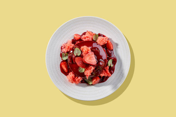 istock A vibrant and refreshing stack of pancakes topped with fresh strawberries and a drizzle of sweet berry sauce. 2193502251
