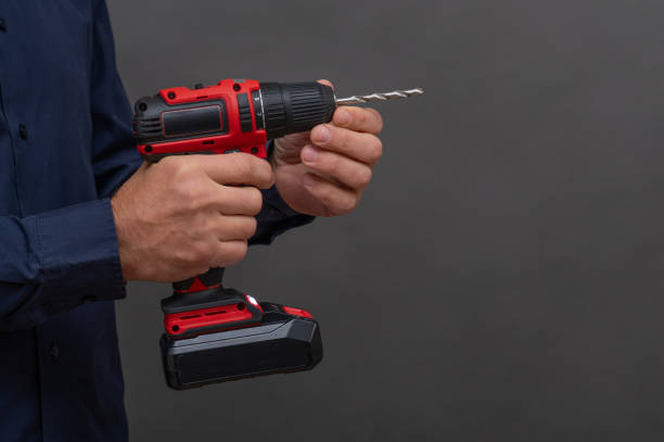 istock installing the drill into the socket of a cordless screwdriver. 2193502375