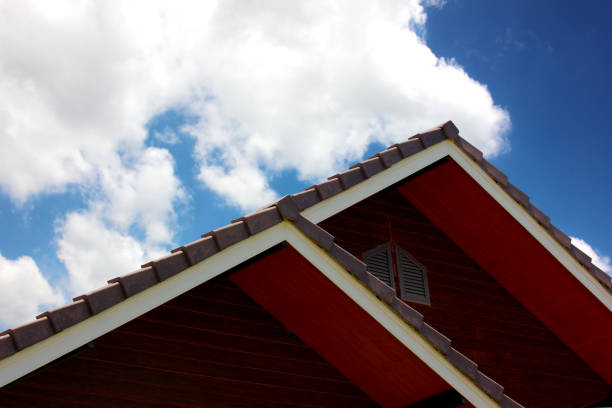 A perfectly tiled roof on a Buddhist temple in Asia. You can see the orange bricks and the cloudy sky very well!