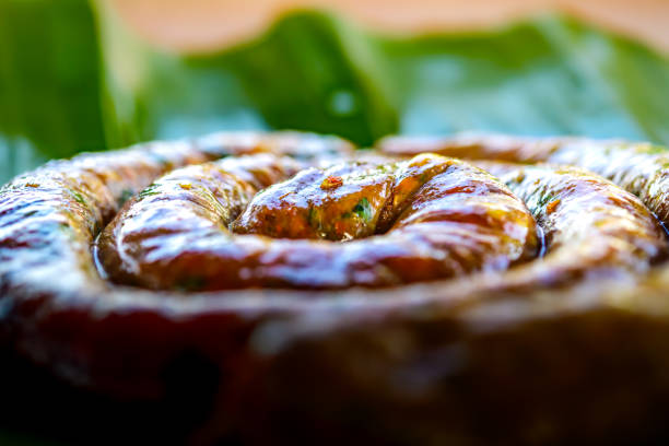 Food Series : Grilled Sai Oua on banana leaf. Sai Aua or Northern Thai Spicy Sausage. Lanna style sausage. Local cuisine of northern Thailand. Chiang Mai sausage on banana leaves.