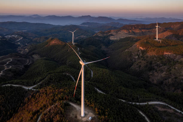 istock Morning light shining on wind turbines on the mountains 2193505340