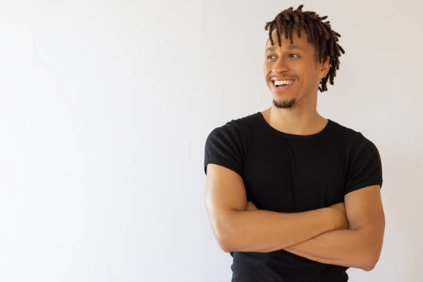 istock Afro haired man with arms crossed 2193507579
