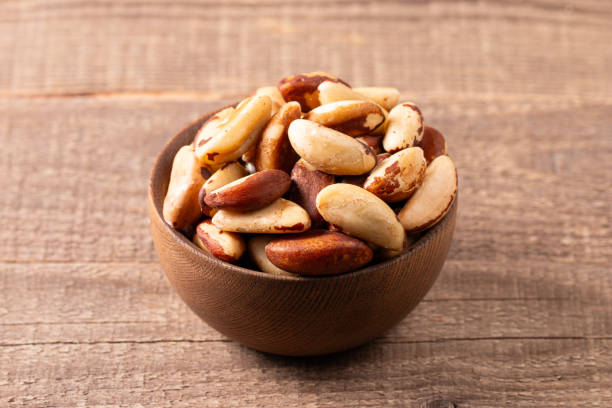 istock Brazil nuts in a bowl on wooden background 2193509577