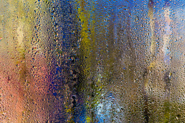 colored background of water droplets. condensation on the glass