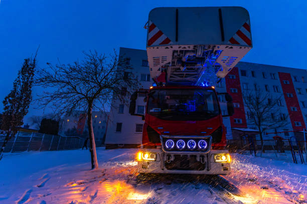 istock Red fire truck with a long ladder, difficult weather conditions, falling snow, rescue operation - horsefly poisoning, carbon monoxide poisoning 2193512231