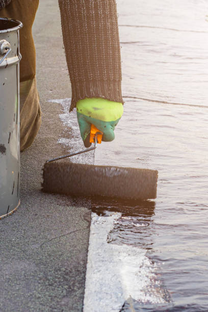 istock a young worker treats a roof with bitumen primer before applying rolled asphalt roofing using a torch 2193513353