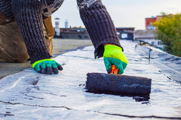 istock a young worker treats a roof with bitumen primer before applying rolled asphalt roofing using a torch 2193513355