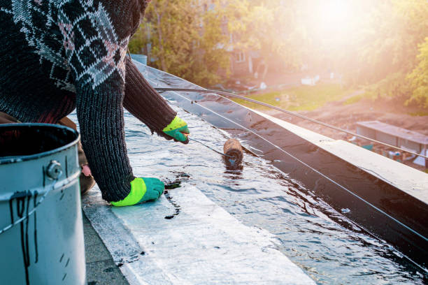 istock a young worker treats a roof with bitumen primer before applying rolled asphalt roofing using a torch 2193513358