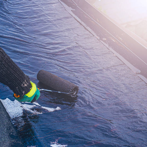 istock a young worker treats a roof with bitumen primer before applying rolled asphalt roofing using a torch 2193513362