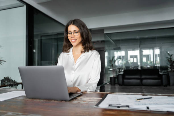 istock Smiling young middle eastern business woman specialist working focused on laptop computer. Middle aged latin hispanic investor, bank worker using pc for analysing, network at workplace desk in office 2193514278
