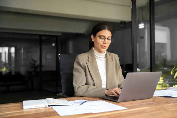 istock Smiling young middle eastern business woman specialist working focused on laptop computer. Middle aged latin hispanic investor, bank worker using pc for analysing, network at workplace desk in office 2193514301