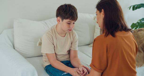 istock Young mother is scolding her son at home, addressing his misbehavior with a serious expression in domestic. Family moment concept. 2193515690