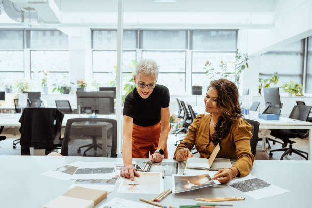 Mature women working in creative industry and finding solutions for interior design for clients