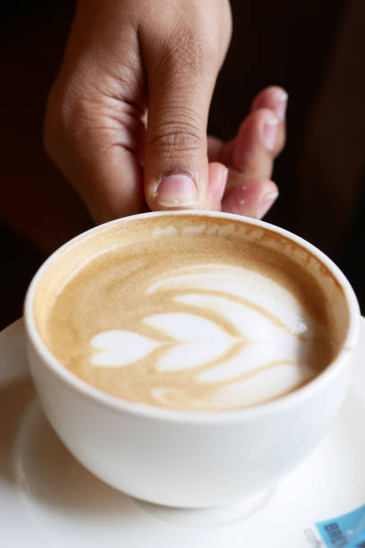 istock women holding a coffee cup 2193517390
