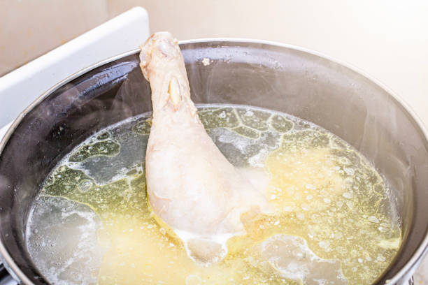 istock boiled chicken in a pot broth close-up with blurred background and front 2193517608
