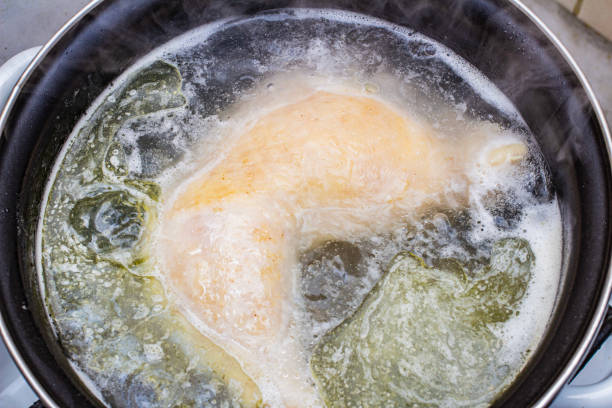 istock boiled chicken in a pot broth close-up with blurred background and front 2193517612