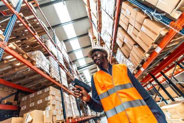 istock Manual worker scanning packages to deliver in a warehouse 2193517962