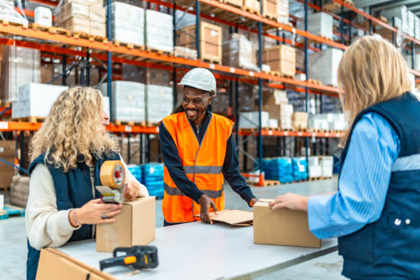 istock Multi-ethnic workers preparing parcels to deliver in a warehouse 2193518020