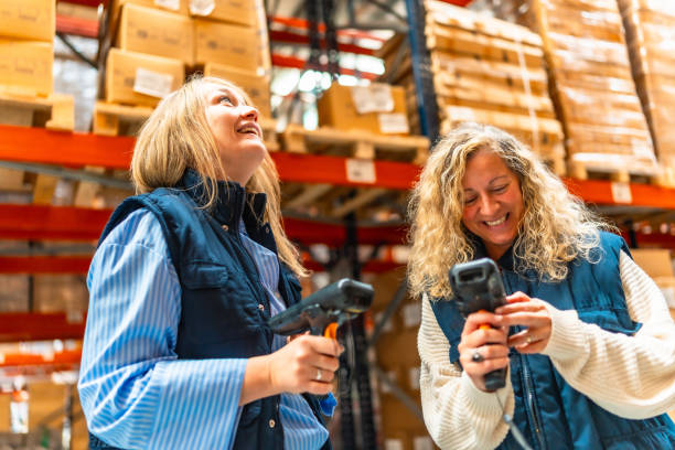 istock Happy female workers scanning boxes in a warehouse 2193518058