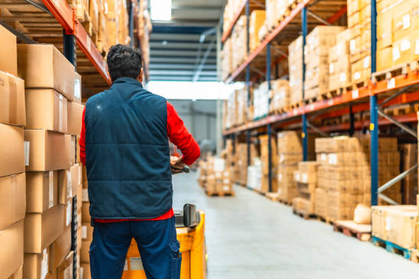 istock Latin worker with machinery in the logistics warehouse 2193518066