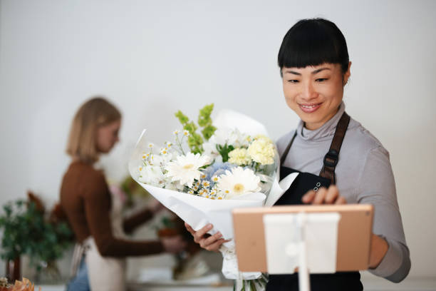 istock Florists Arranging and Displaying Bouquets in a Bright Floral Shop 2193518096